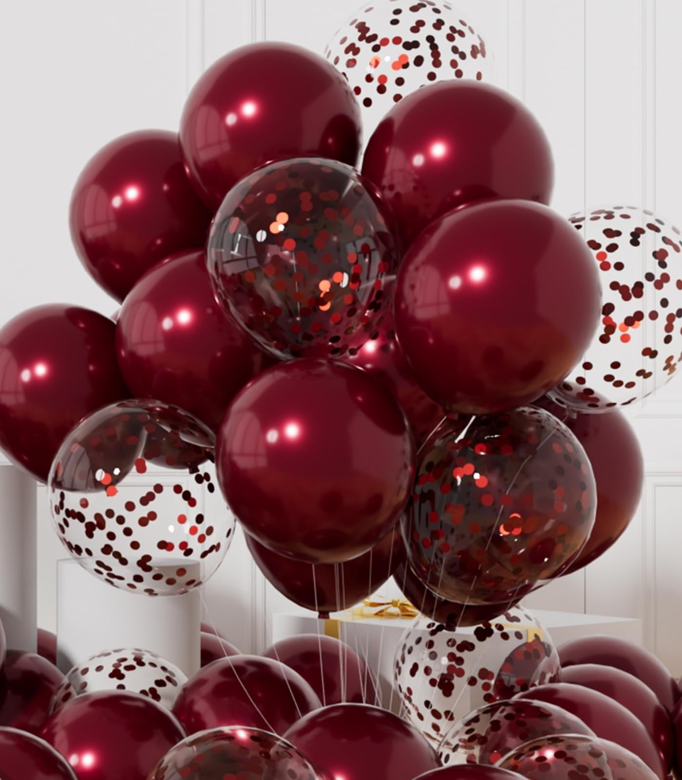 A large cluster of burgundy and confetti balloons arranged in a decorative display.