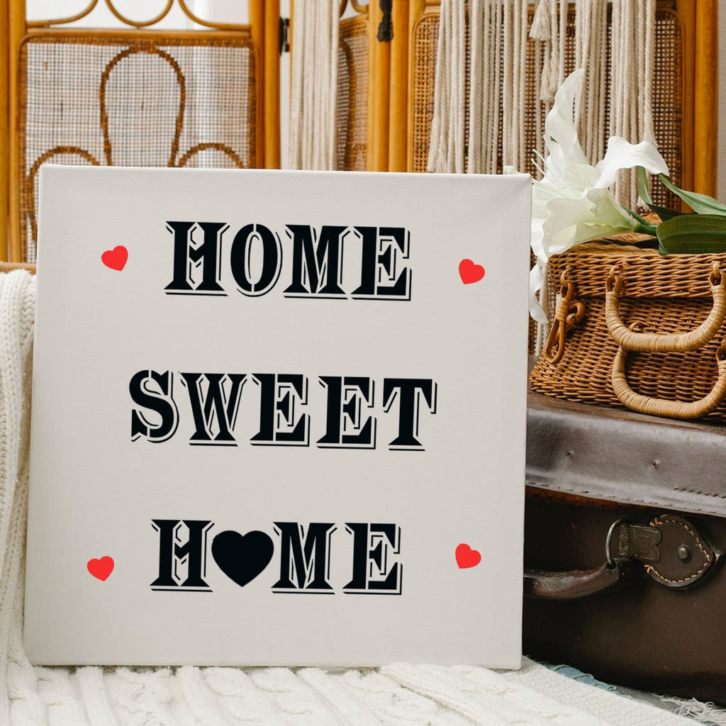 Canvas sign with 'HOME SWEET HOME' text and red hearts, styled with a vintage suitcase and basket.