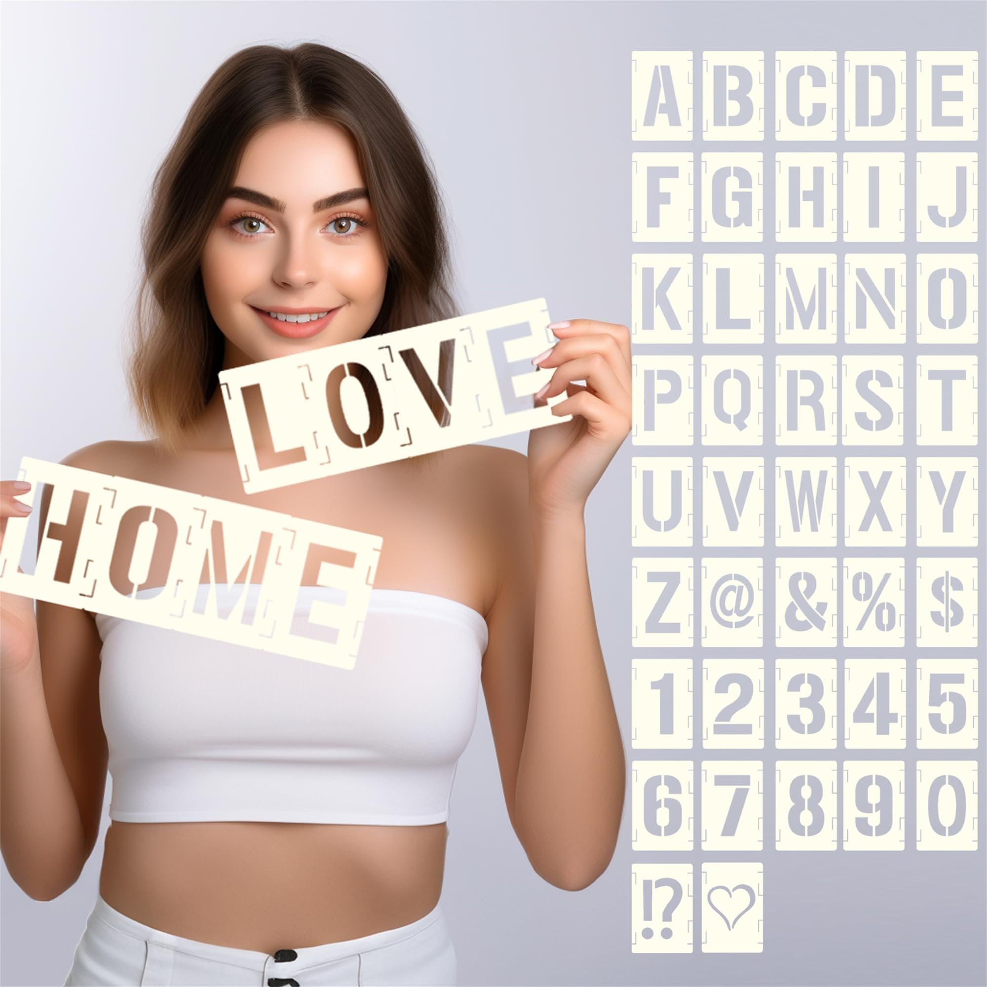Woman holding stencils spelling HOME and LOVE, with a grid of alphabet and number stencils in the background.