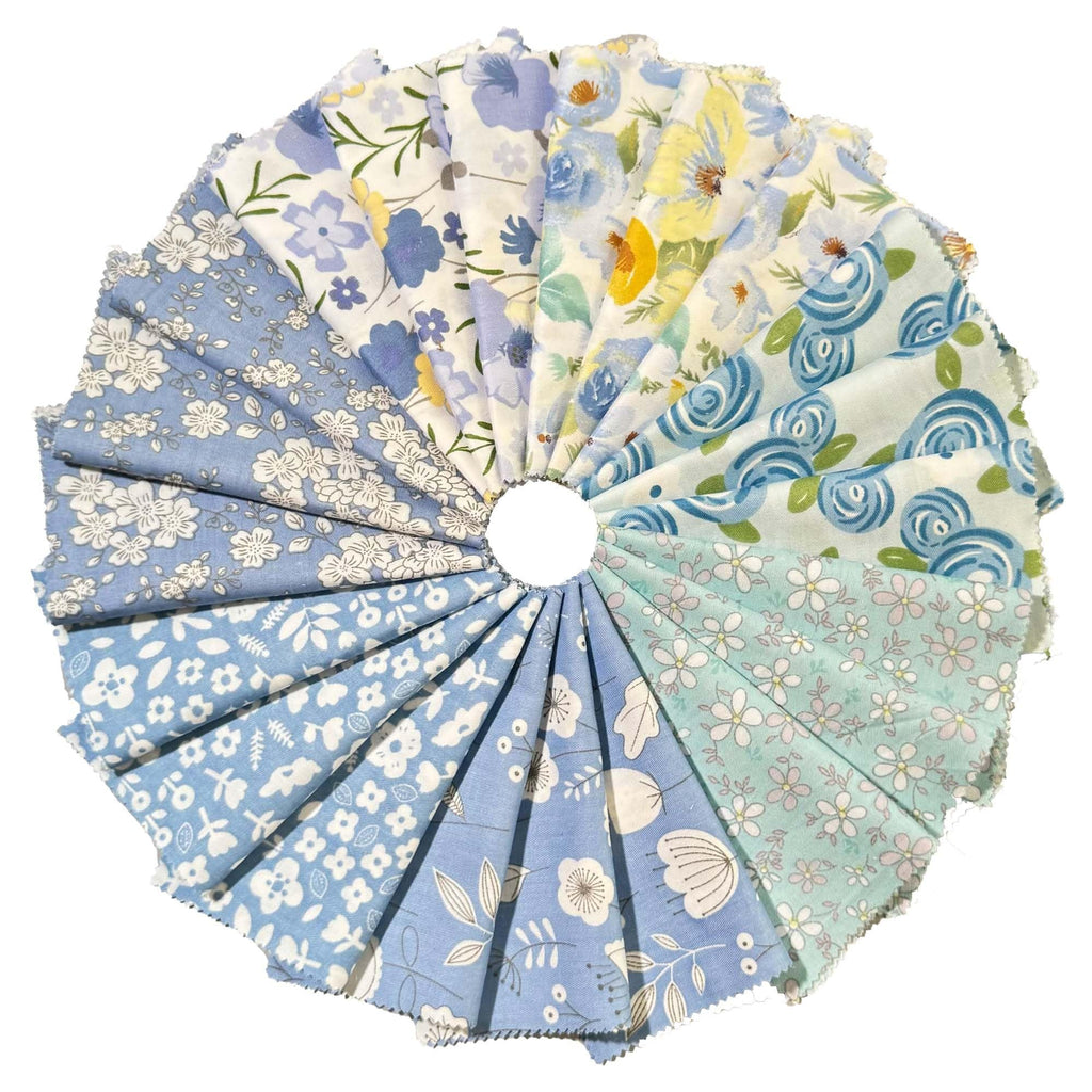 Fan of 42 blue floral fabric squares for quilting, arranged in a circle on a white background.