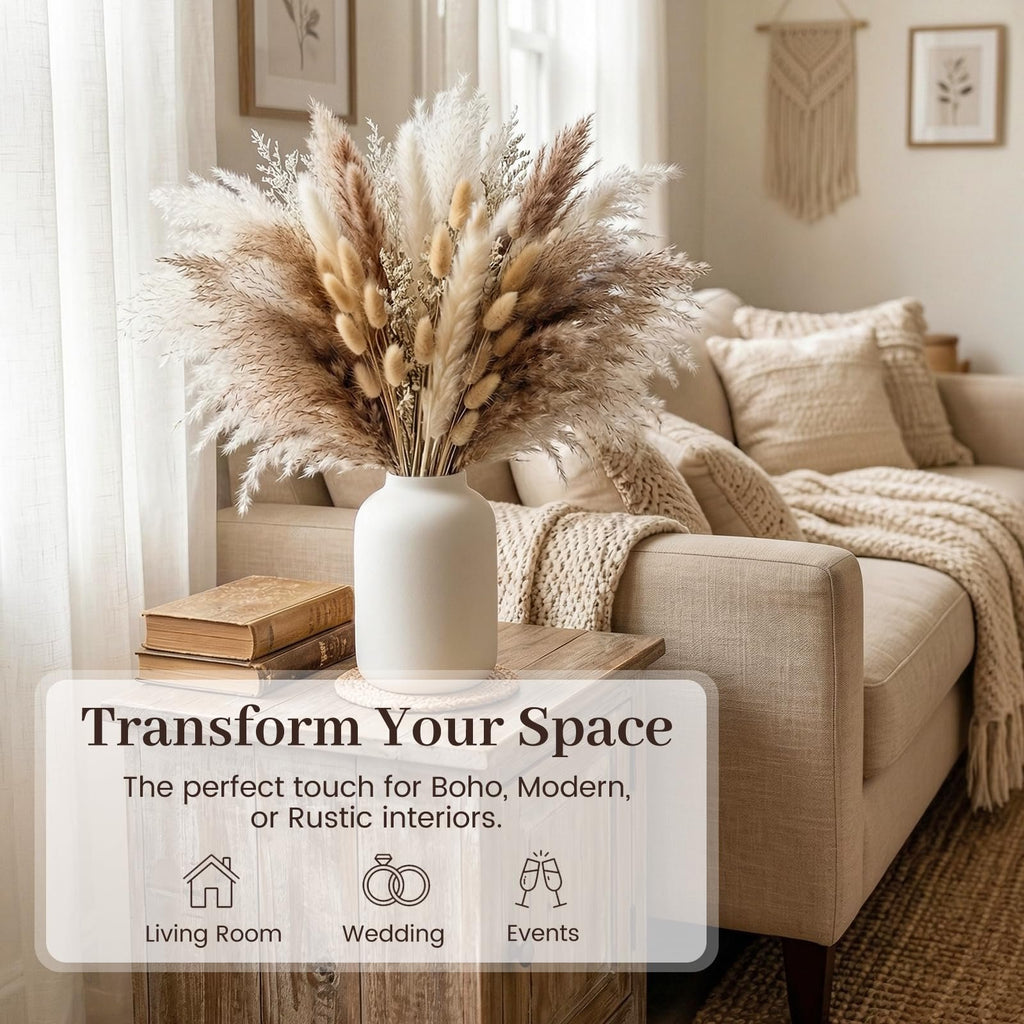 Boho dried pampas grass and bunny tail arrangement in a white vase on a side table next to a sofa.
