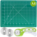 Green self-healing cutting mat with grid lines, angles, and inch/cm rulers, shown with a 45mm rotary cutter and two replacement blades.