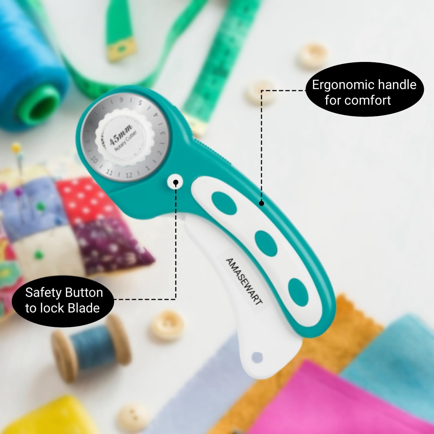 Teal and white 45mm rotary fabric cutter with sewing notions, showing safety button and ergonomic handle.