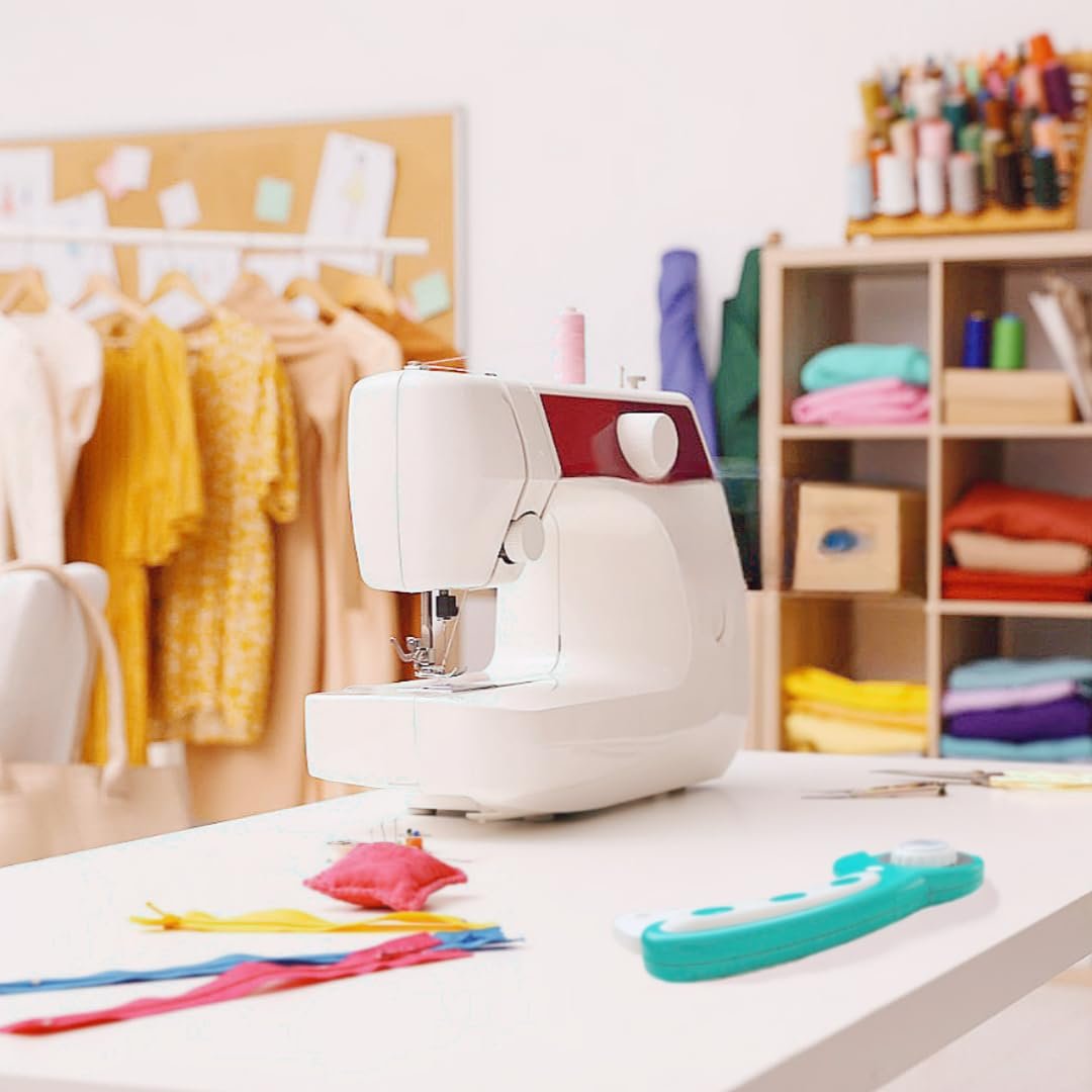 Sewing machine and rotary cutter on a table in a craft room with fabric and thread supplies