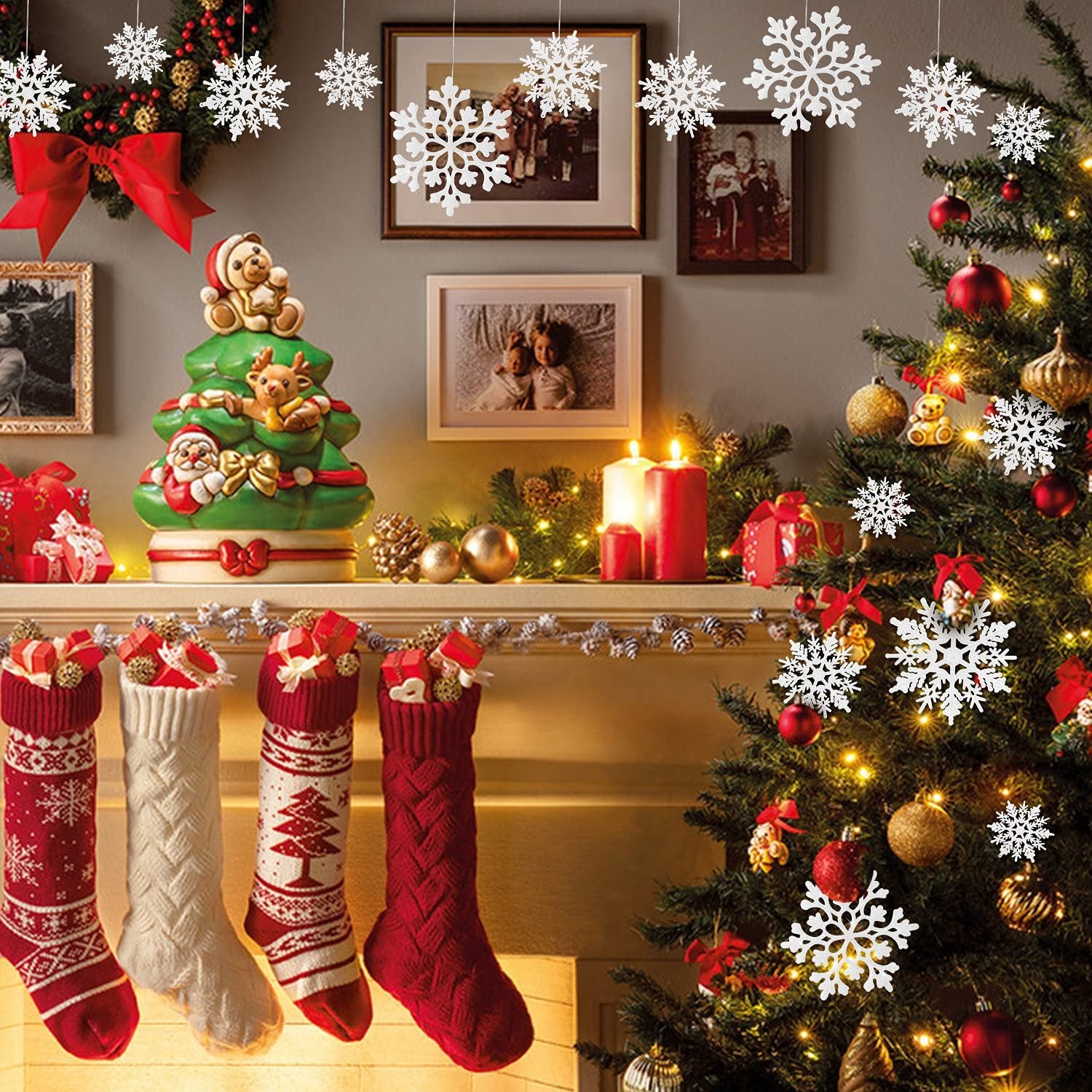 Christmas tree decorated with ornaments, stockings hung on a mantle, and snowflake decorations hanging.