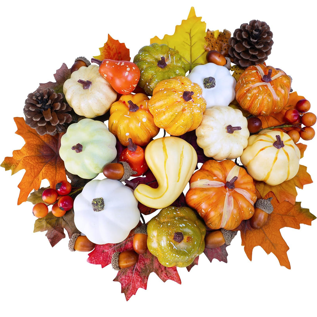 Assortment of artificial pumpkins, gourds, pinecones, acorns, berries, and maple leaves on a white background.