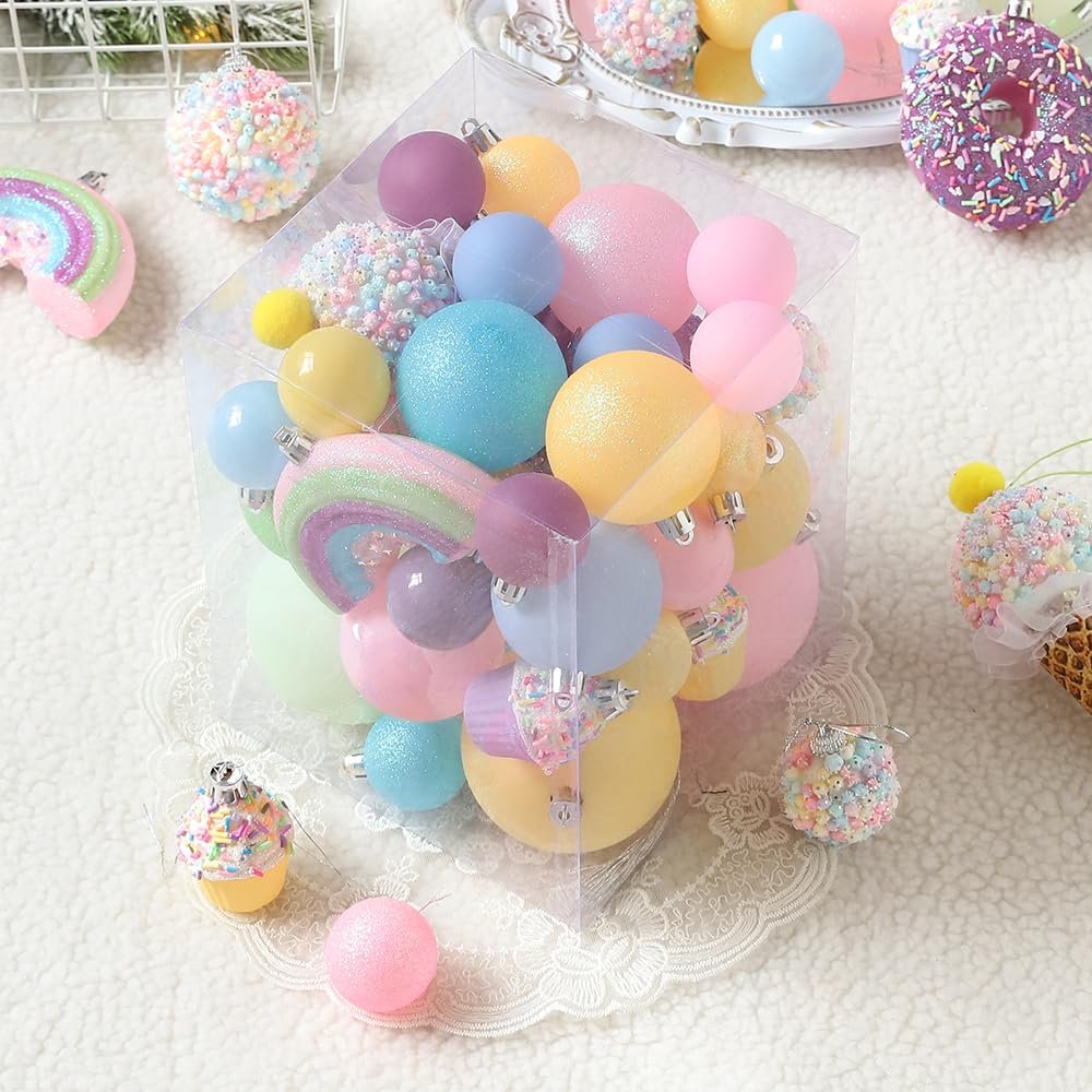 Pastel Christmas ornaments in a clear box, including rainbow, donut, and cupcake shapes.