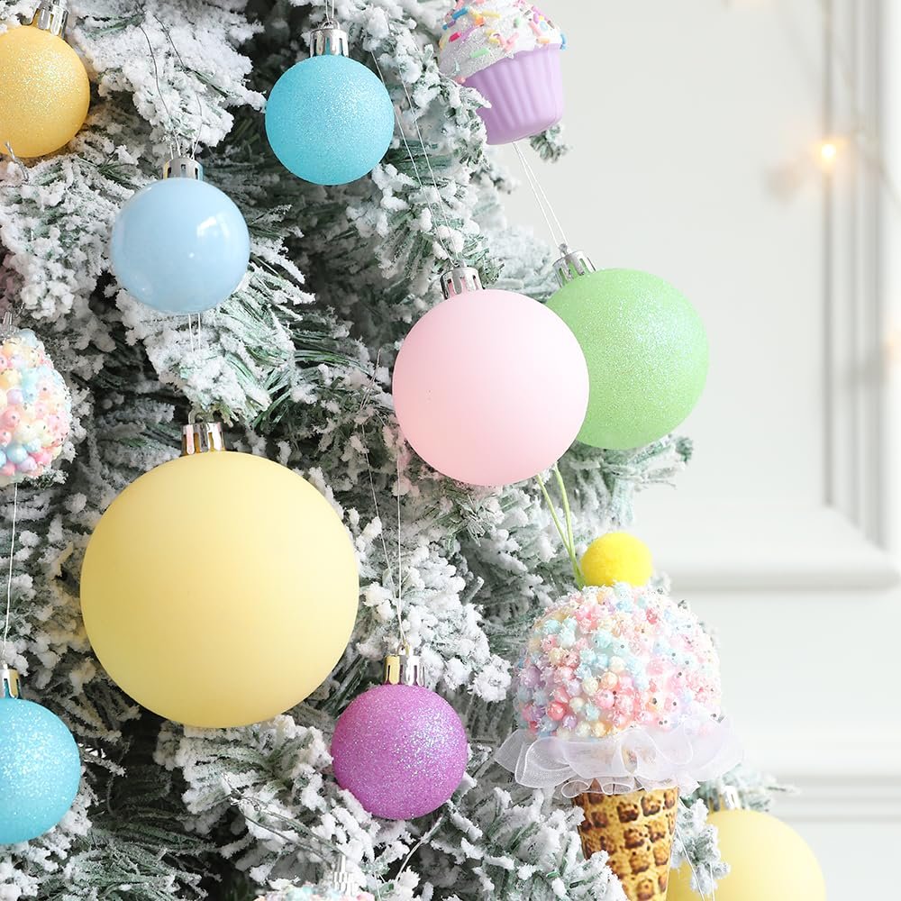 Pastel Christmas ornaments including balls and ice cream cone shapes hanging on a flocked tree.