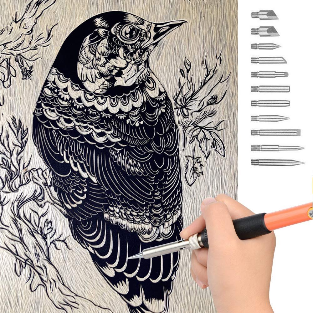 Wood burning kit pen held by hand, demonstrating on a detailed bird carving with various tips shown on the right.