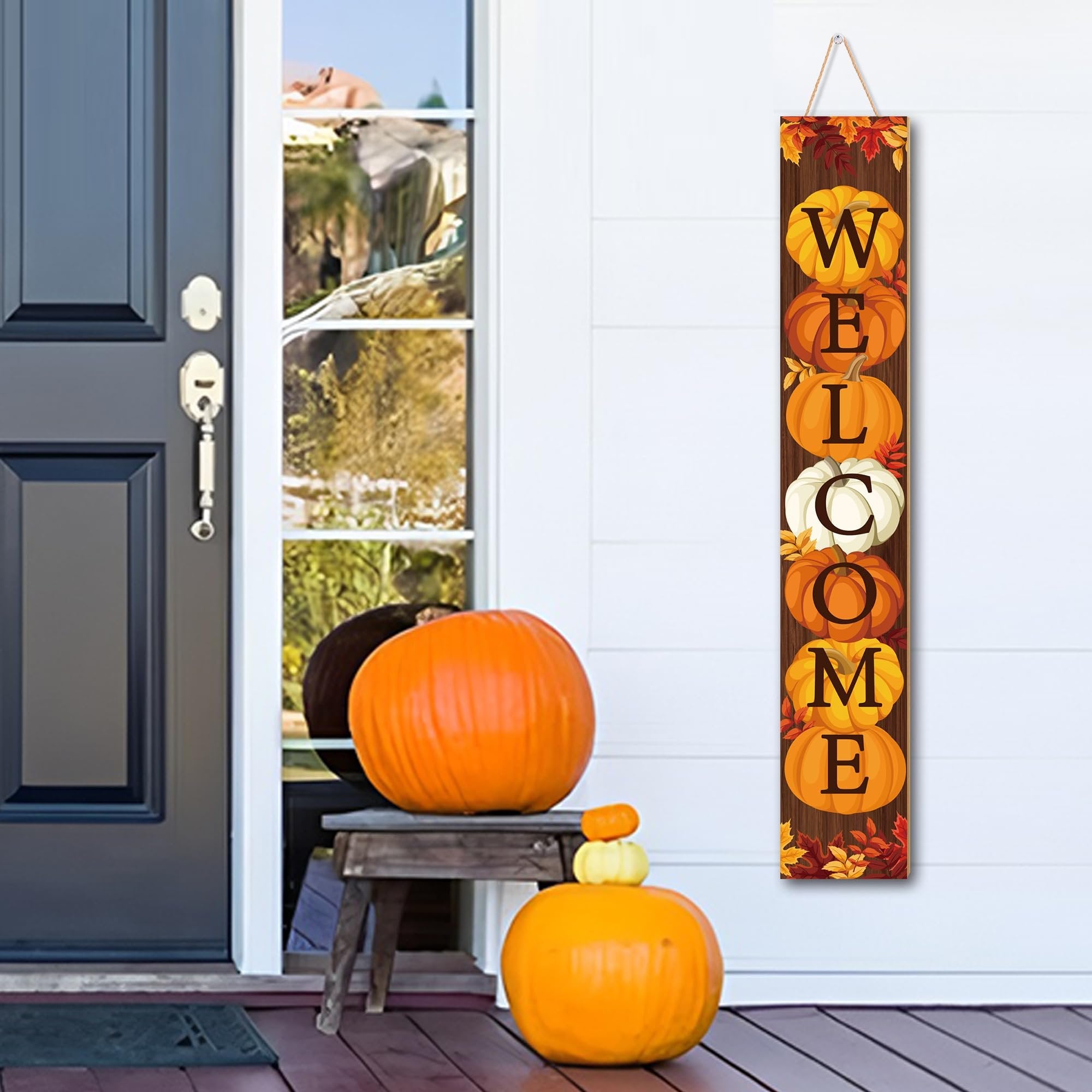 Vertical fall porch sign with pumpkins and maple leaves spelling WELCOME, hanging by a door with pumpkins.