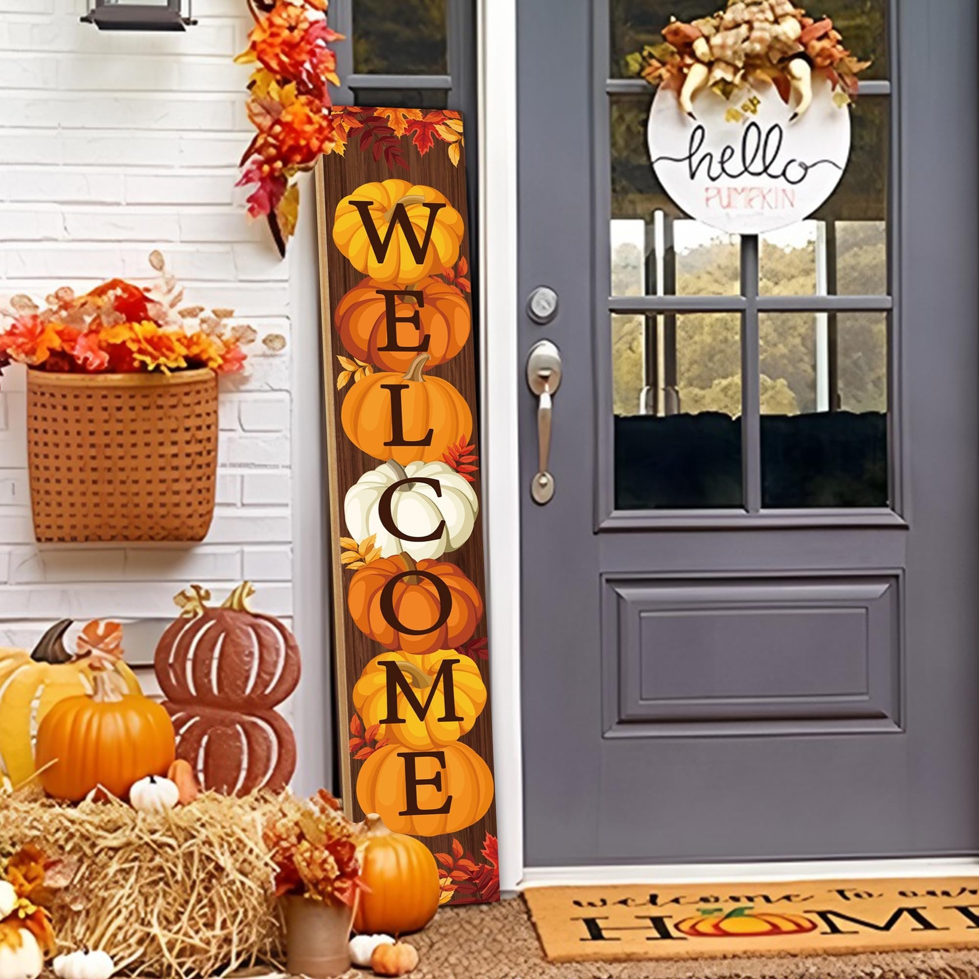 Vertical wooden porch sign with pumpkins spelling WELCOME, displayed on a porch with fall decorations.