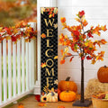 Vertical welcome sign with autumn leaves and pumpkins on a porch railing