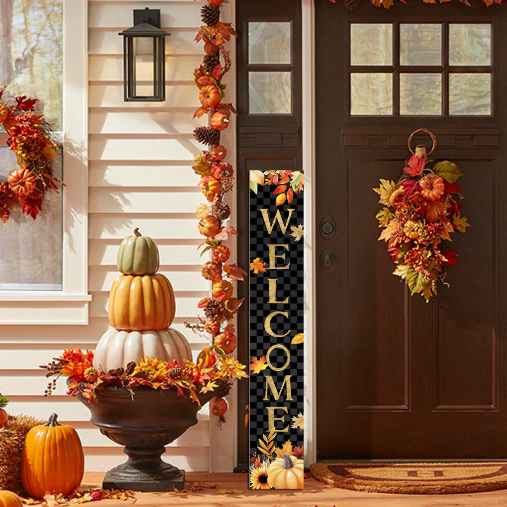 Vertical porch sign with "WELCOME" text and autumn leaves, displayed on a porch with pumpkins and fall decor.