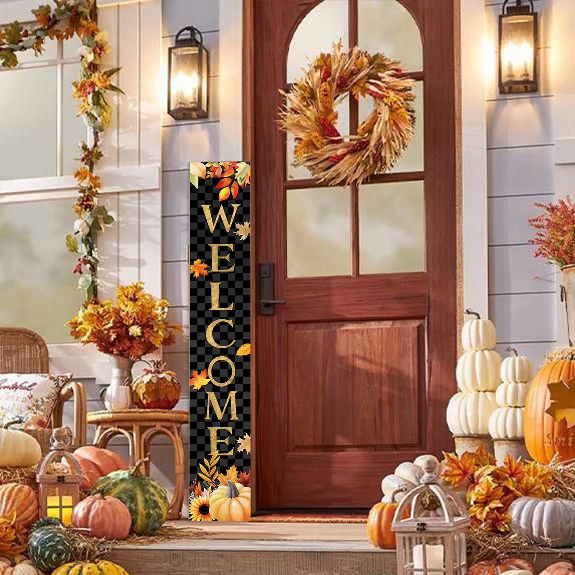 Vertical autumn porch sign with 'WELCOME' text and fall leaves, displayed on a porch with pumpkins and a wreath.