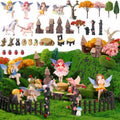 Fairy garden miniature set with figurines, unicorns, houses, trees, and moss on a grassy landscape.