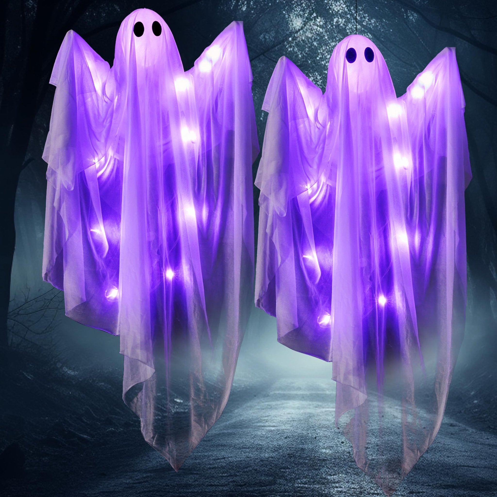 Two purple light-up hanging ghost decorations with black eyes against a dark, misty forest background.