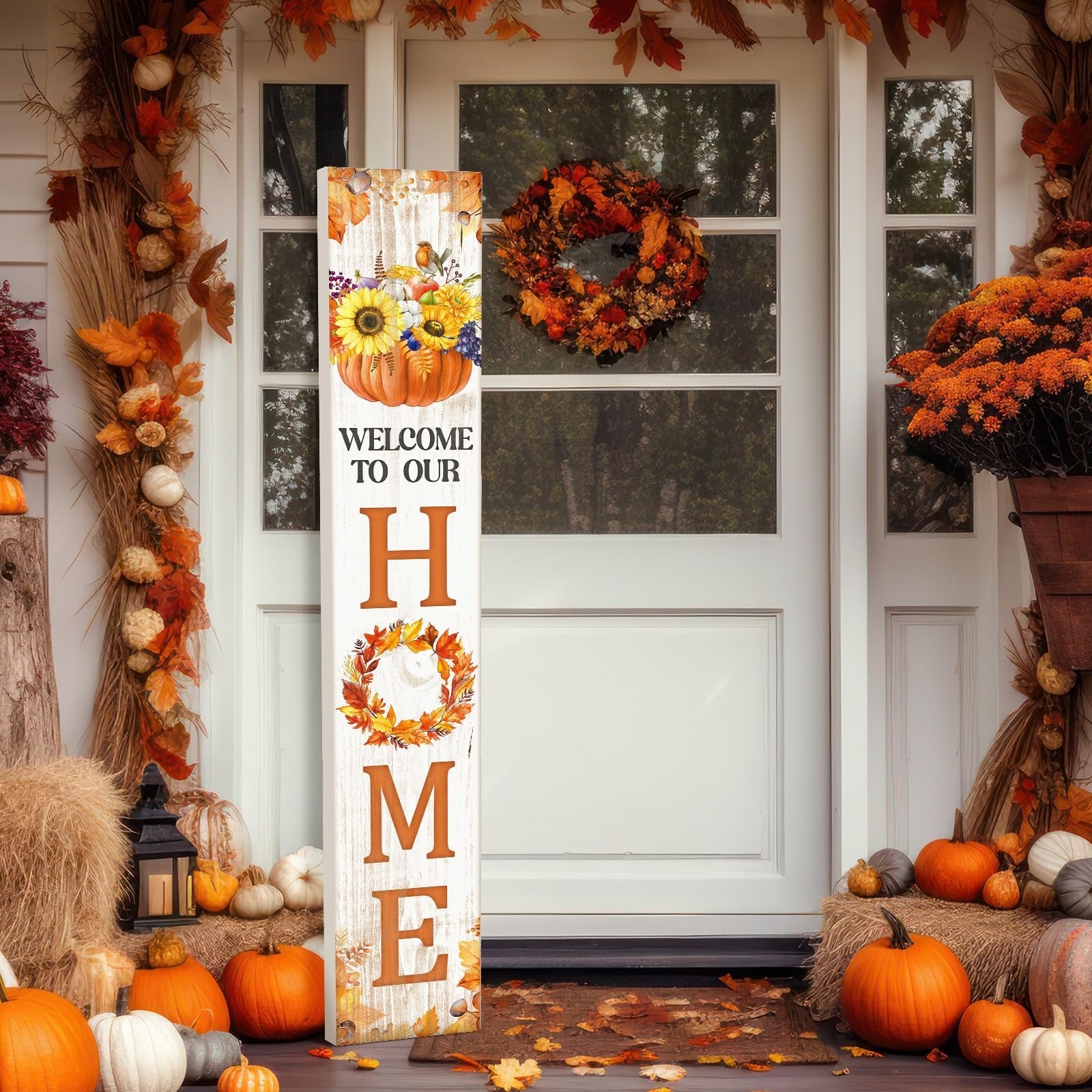Vertical porch sign with pumpkin and sunflowers saying WELCOME TO OUR HOME, decorated for fall with pumpkins and autumn leaves.