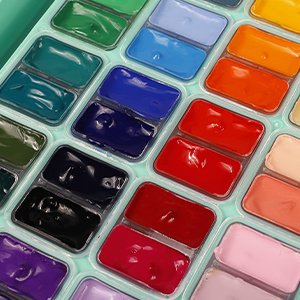 Close-up of a 48-color gouache paint set in twin jelly cups, showing various vibrant colors.
