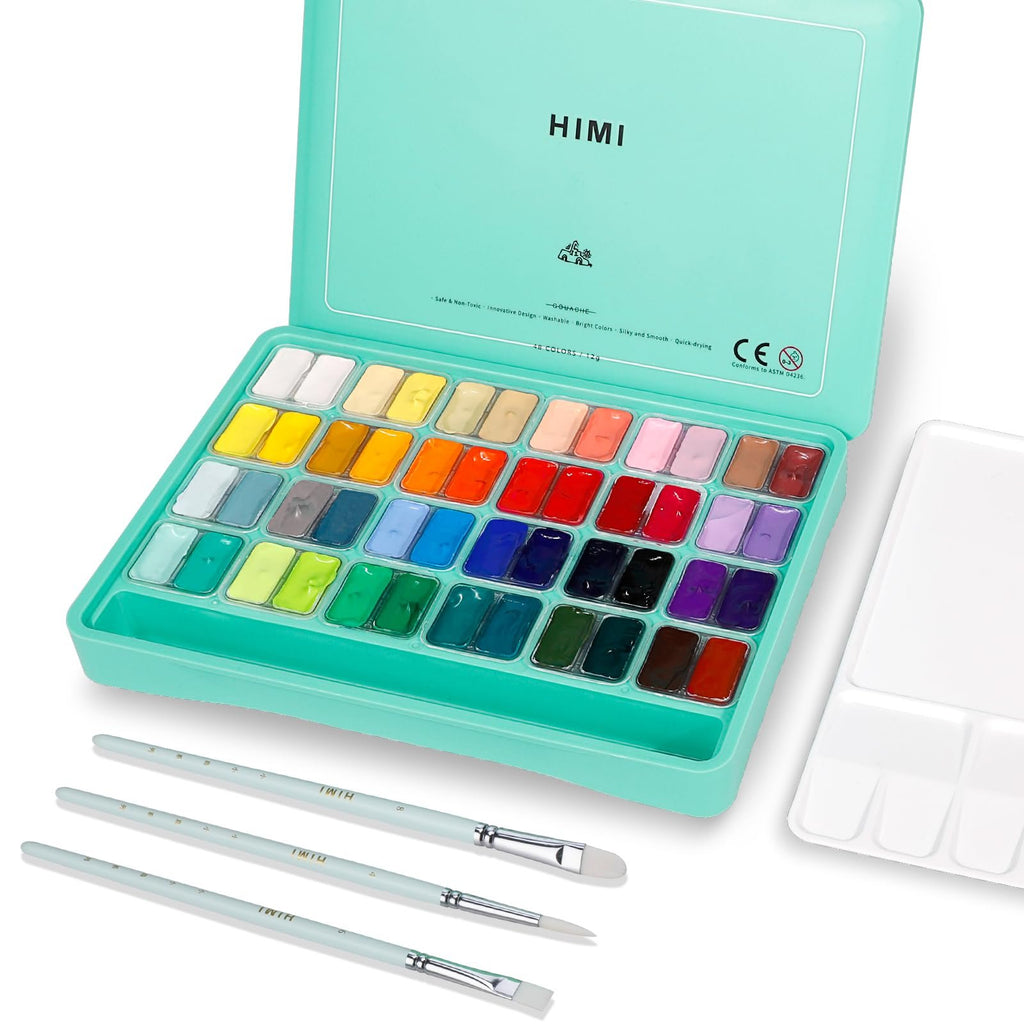 Open gouache paint set with 48 colors, three brushes, and a palette on a white background.