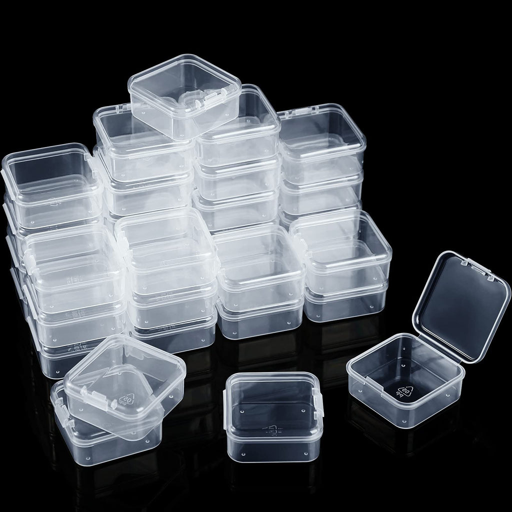 Stack of clear plastic storage boxes with hinged lids on a black background, one box open.