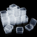 Stack of clear plastic storage boxes with hinged lids on a black background, one box open.