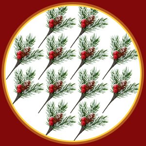 Artificial pine branches with red berries and pine cones, dusted with snow, arranged in a circular pattern.