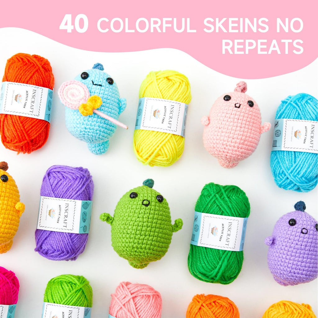 Assortment of colorful yarn skeins and crocheted animal figures arranged on a white background.