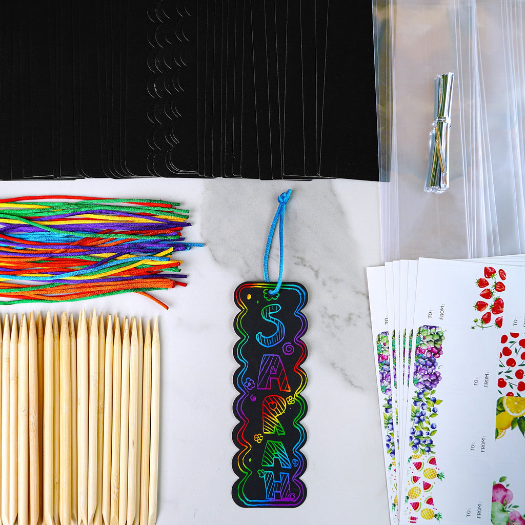Rainbow scratch art bookmarks craft kit contents including black scratch cards, colorful cords, wooden sticks, and gift tags.
