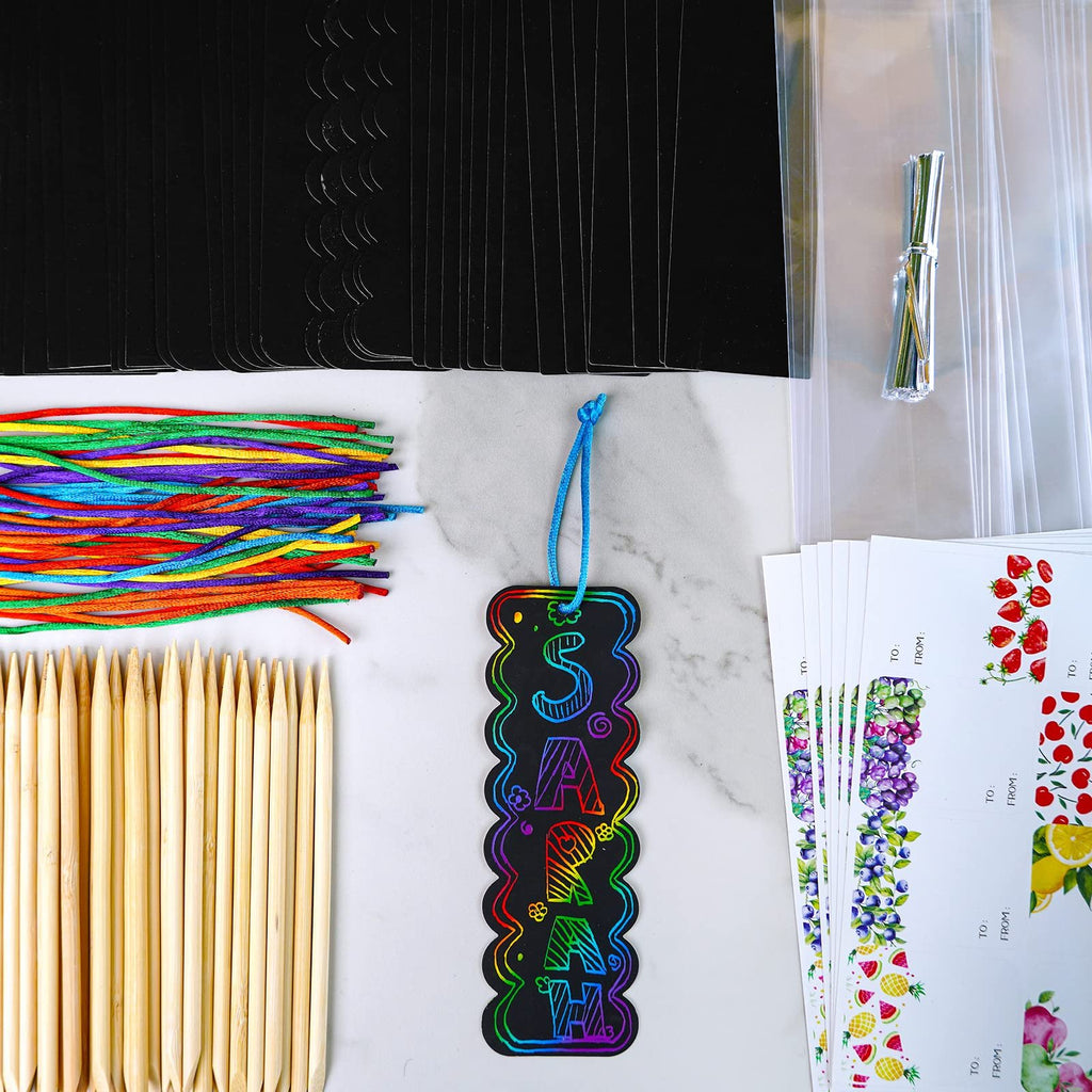 Rainbow scratch art bookmark craft kit contents including black bookmark cards, colorful cords, wooden styluses, and gift tags.