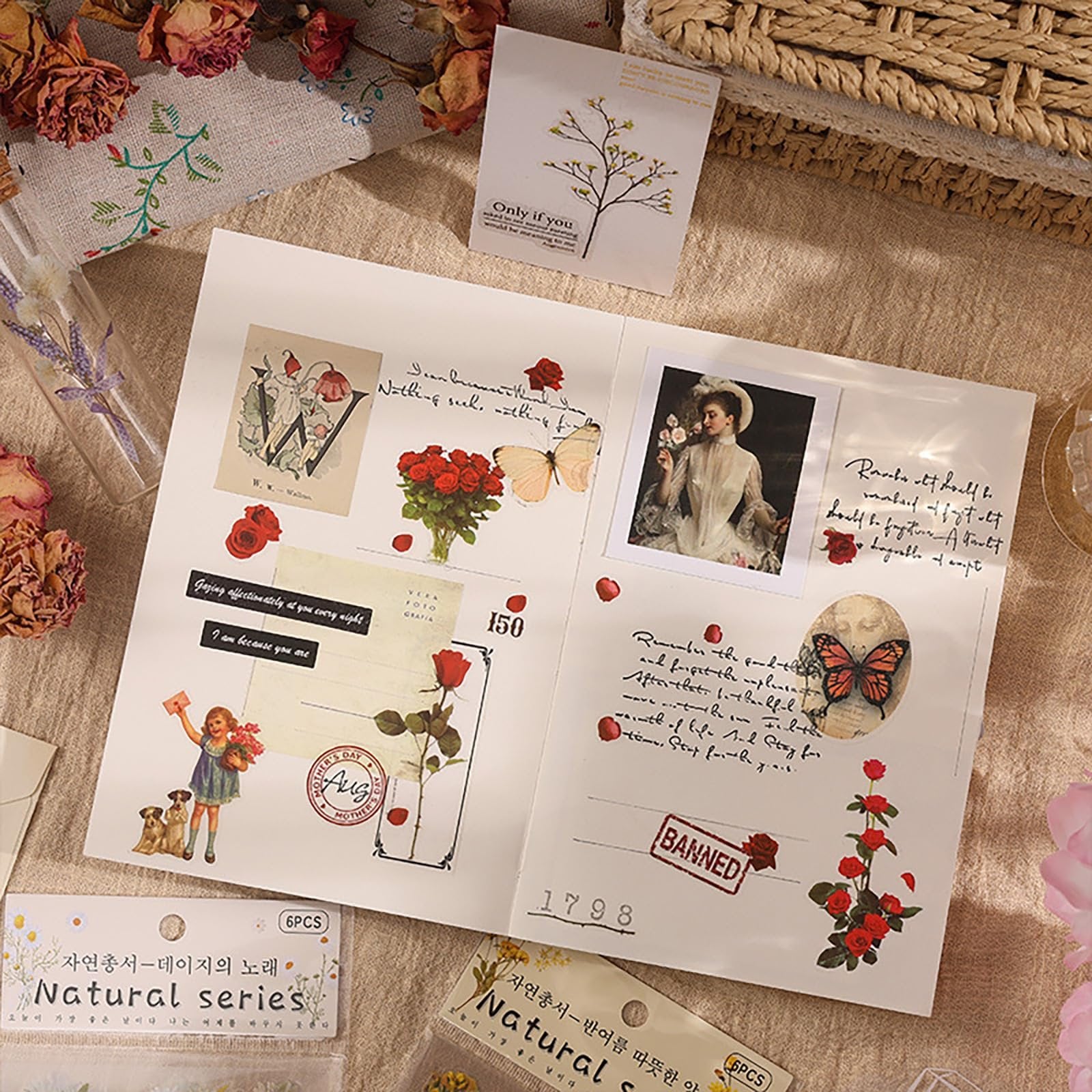 Scrapbook page with various vintage botanical stickers, including roses, butterflies, and a woman in a hat.