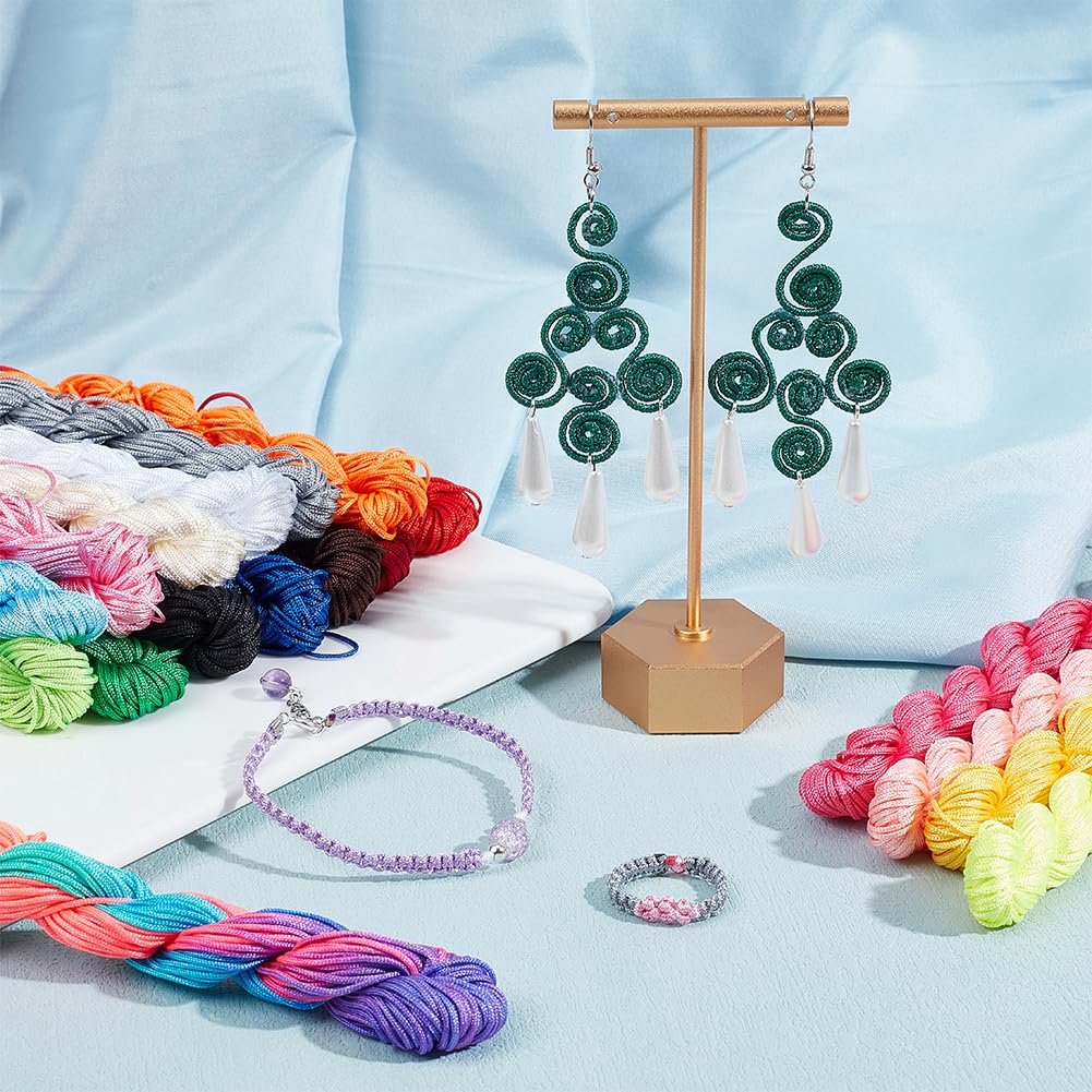 Assorted colorful embroidery threads and finished jewelry pieces including earrings, a bracelet, and a ring.