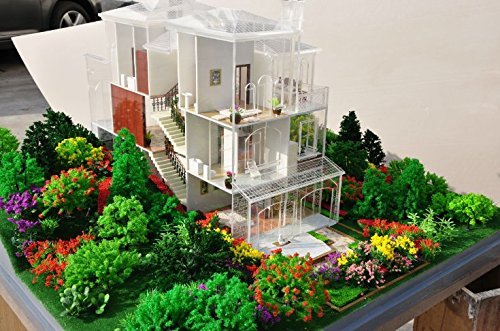 Architectural model of a multi-story house with a detailed garden landscape featuring colorful trees and bushes.