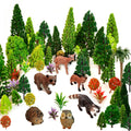Assortment of miniature plastic forest animals and trees on a white background.