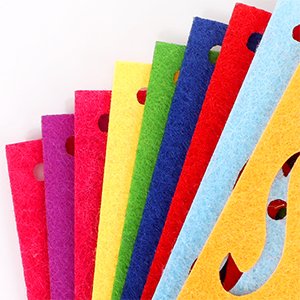 Close-up of a fan of colorful felt banners with cut-out designs, showing multiple colors and textures.