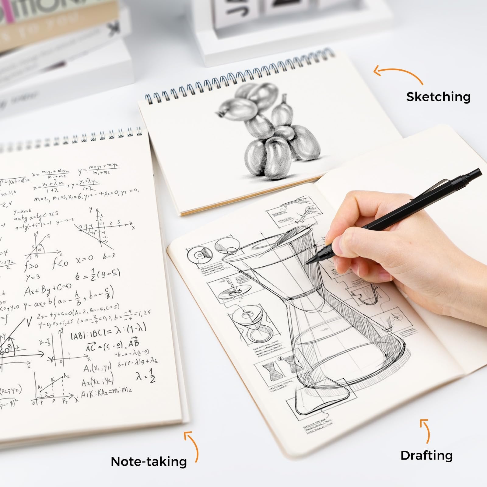 Hand sketching a technical drawing of a coffee maker in a notebook, with math equations in another notebook.