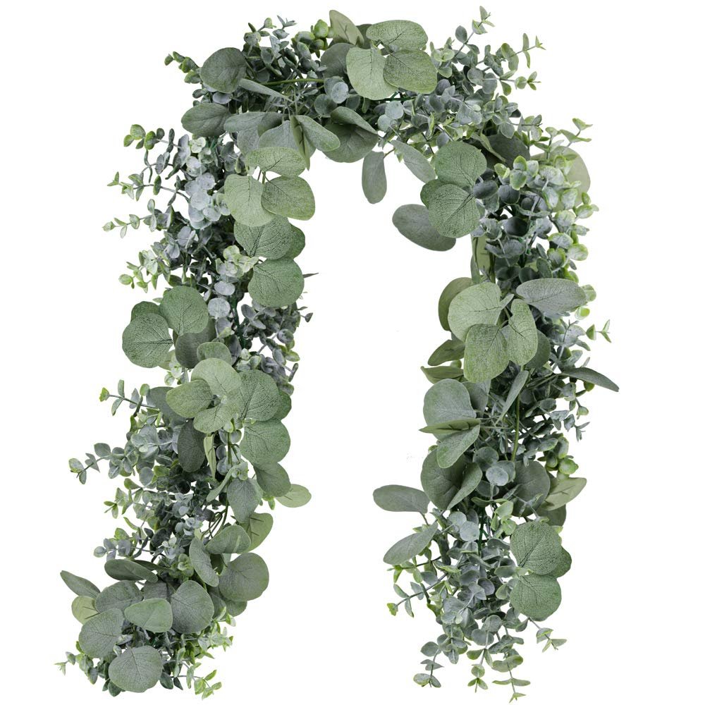 Faux eucalyptus garland with grey-green silk leaves and plastic vine on a white background