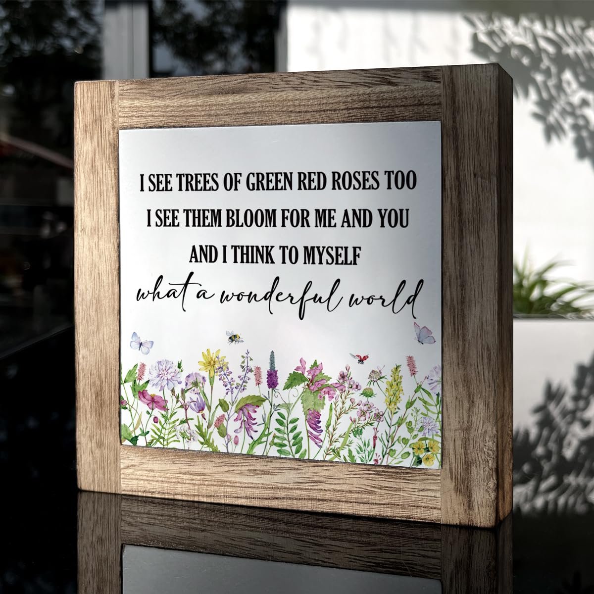 Wooden box sign with floral design and inspirational quote 'What a Wonderful World'.