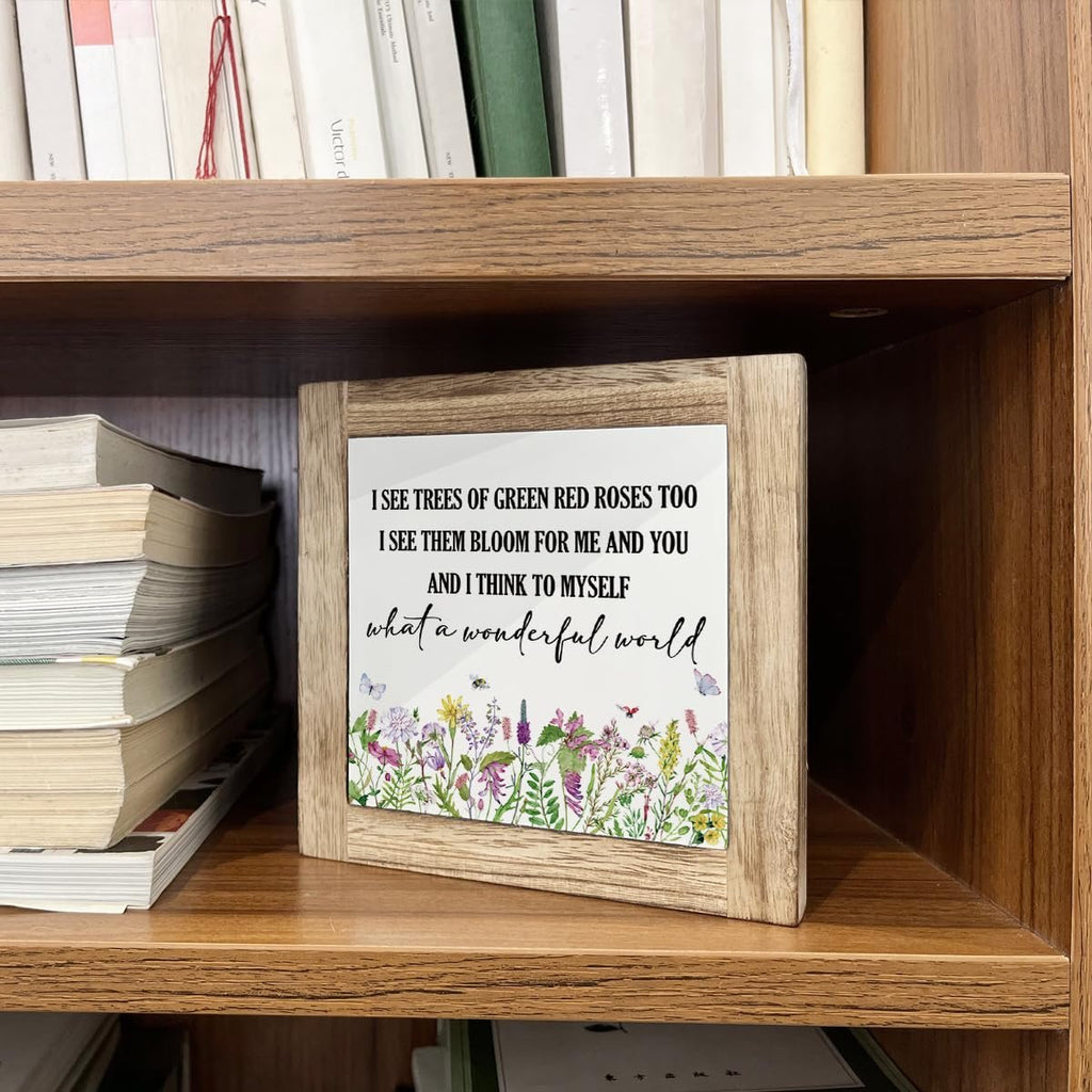 Wooden framed decorative box sign with floral print and inspirational quote 'What a Wonderful World' displayed on a bookshelf.