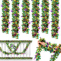 Five metallic tinsel garlands in purple, green, and gold, with Mardi Gras masks and fleur-de-lis accents, displayed on a white railing and held by a hand.
