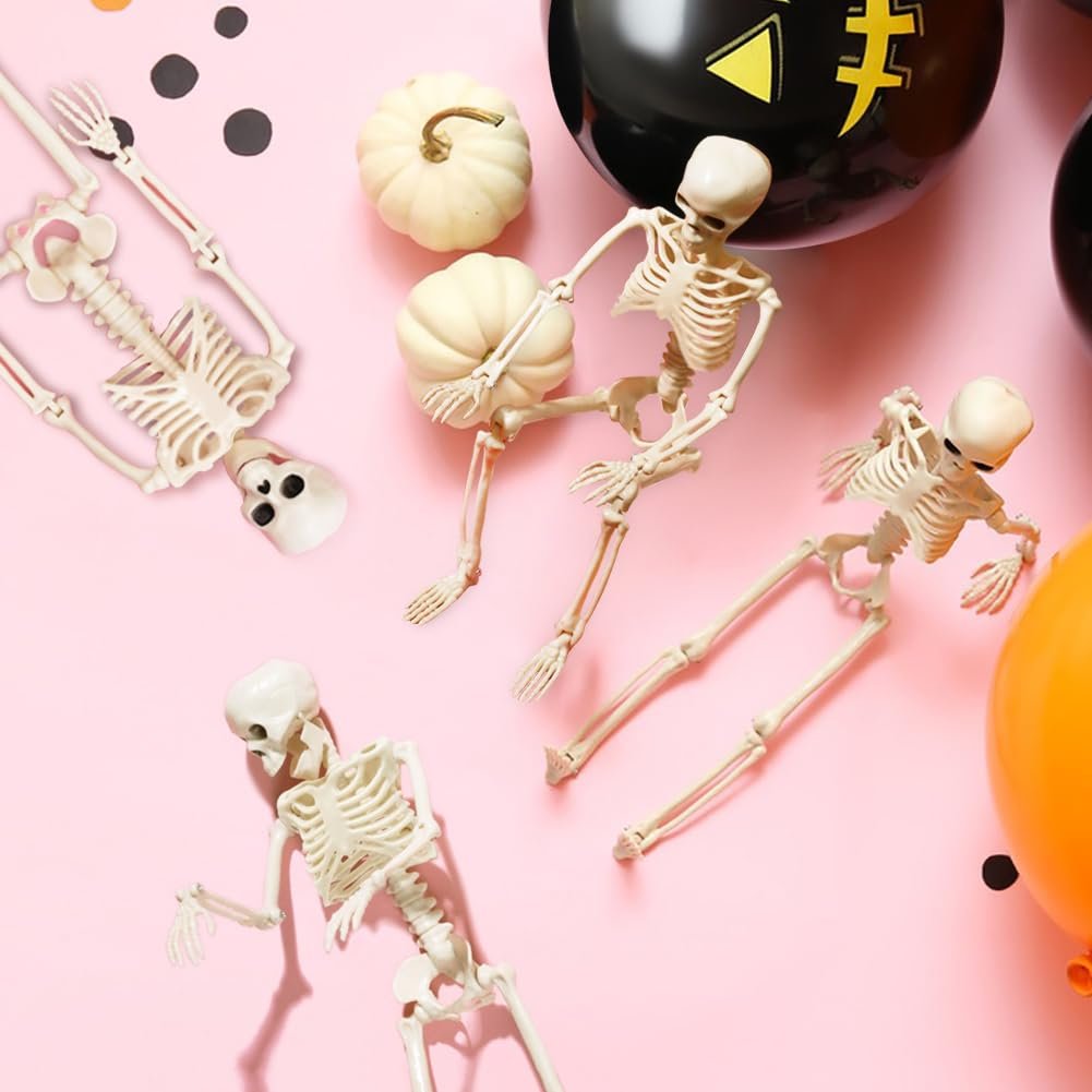 Four Halloween skeletons and two mini pumpkins arranged on a pink background with balloons and confetti.