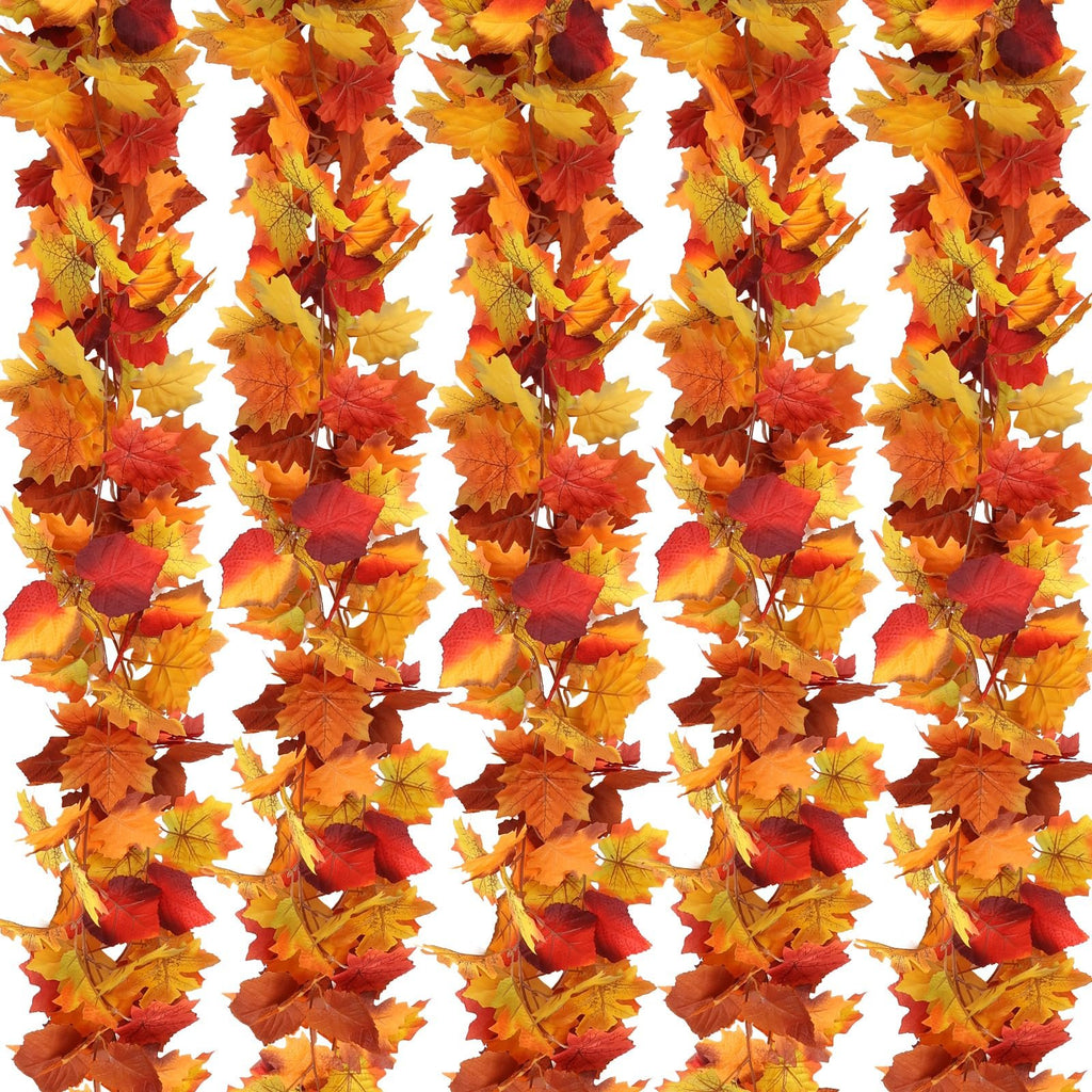 Five strands of artificial maple leaf garland in fall colors of orange, yellow, and red, displayed vertically against a white background.