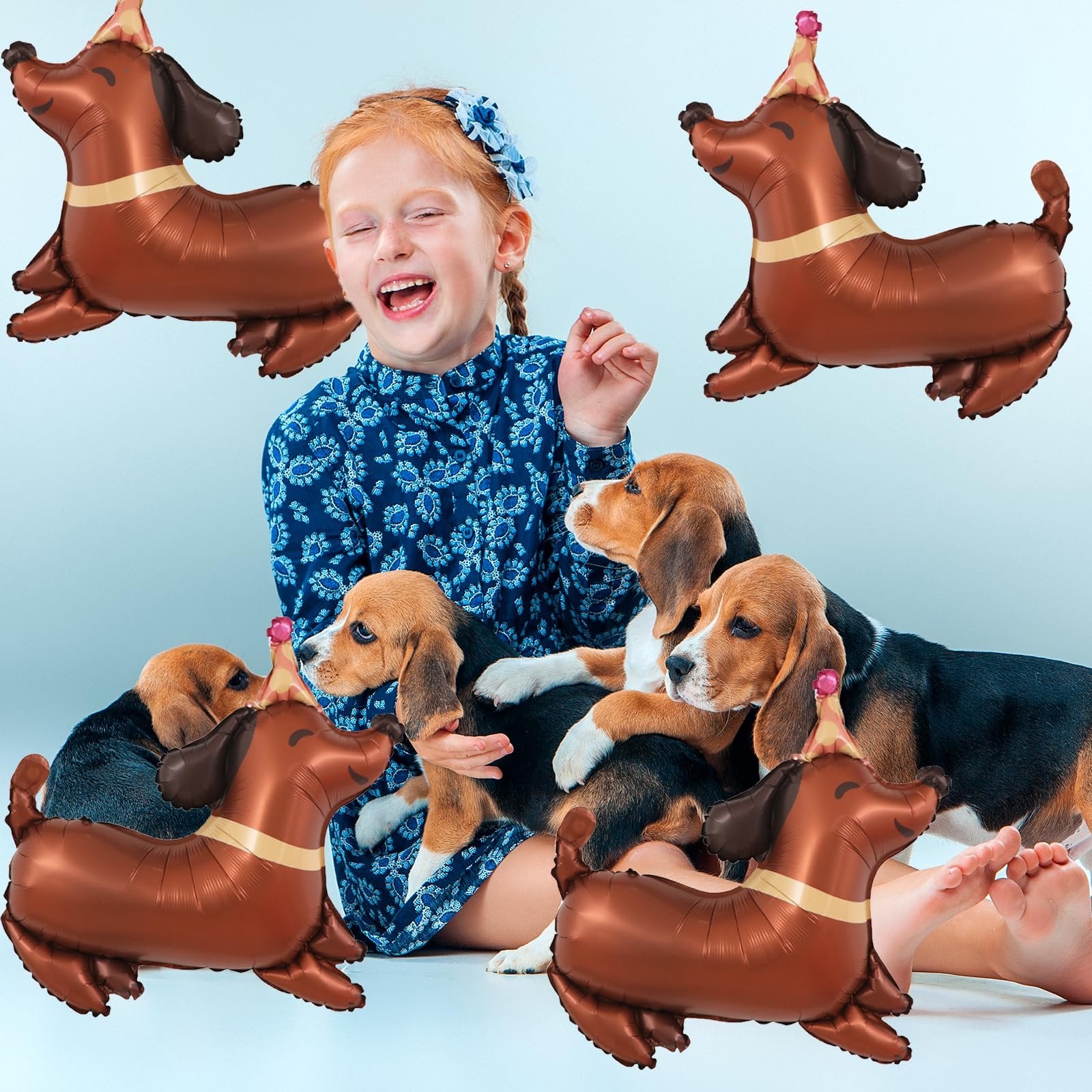 Girl laughing with puppies surrounded by dachshund-shaped balloons wearing party hats