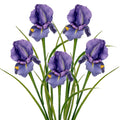 Five purple artificial iris flowers with green stems and leaves on a white background.