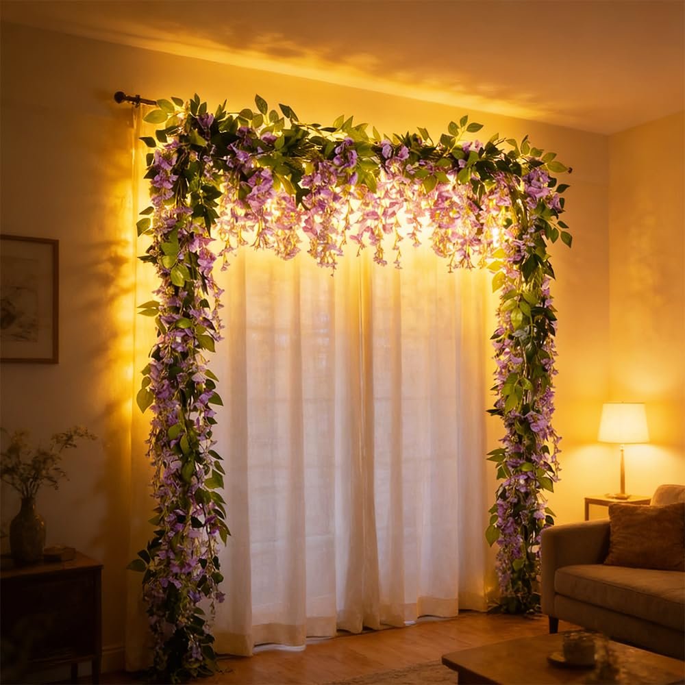 Artificial purple wisteria garland draped over a window arch with warm lighting.