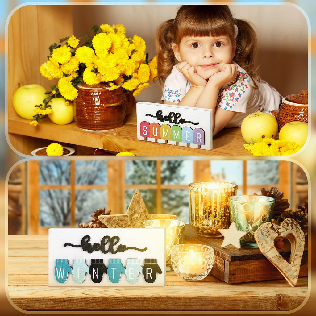 Seasonal table signs with 'hello SUMMER' and 'hello WINTER' inserts, displayed with decor and a child.
