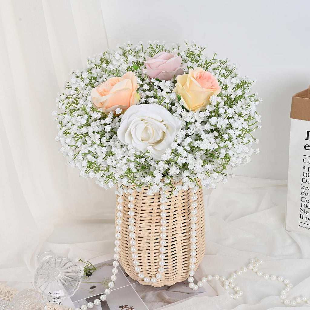 Artificial baby's breath flowers with roses in a woven vase, adorned with pearl strands.