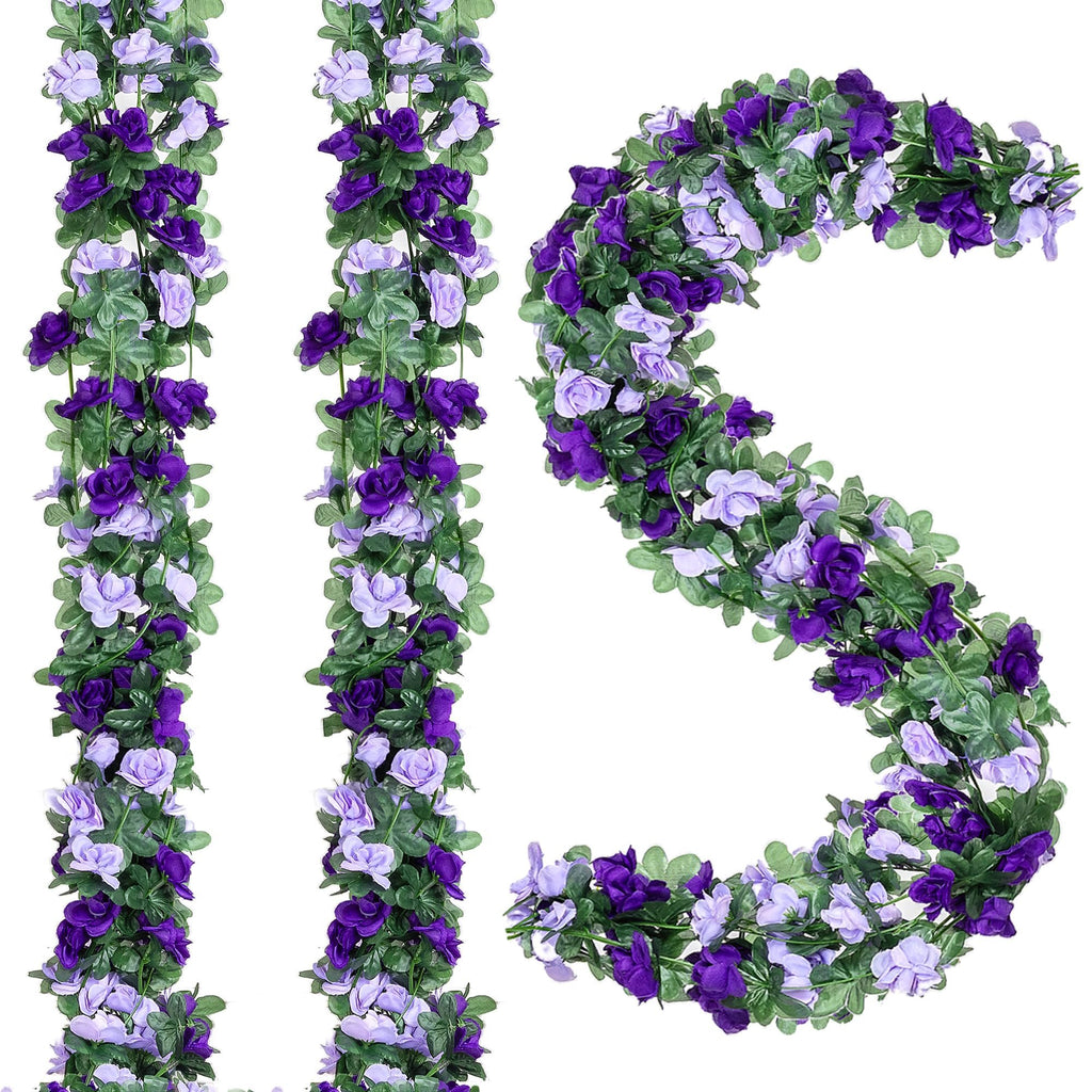 Artificial purple and lavender rose garlands with green leaves on a white background, arranged in vertical strands and a curved shape.