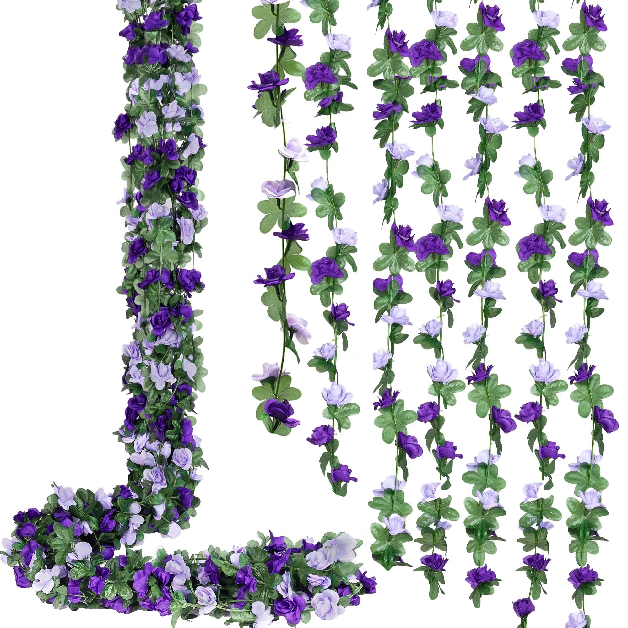 Artificial purple and lavender rose garlands with green leaves, displayed in a cascading arrangement against a white background.