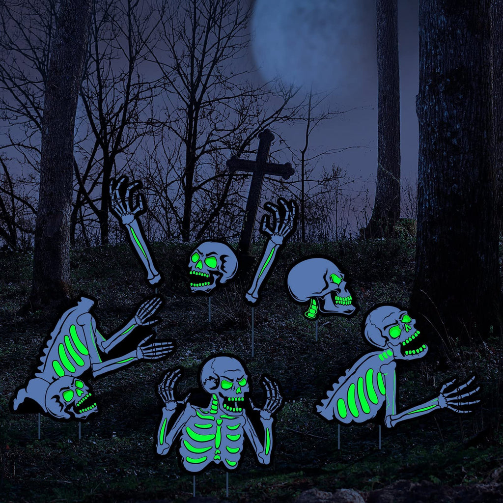 Halloween fluorescent skeleton yard signs with glowing green eyes and bones, set in a dark, spooky forest with a full moon.