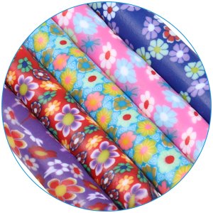 Close-up of five colorful crochet hooks with floral patterns on their soft clay grips, arranged diagonally.